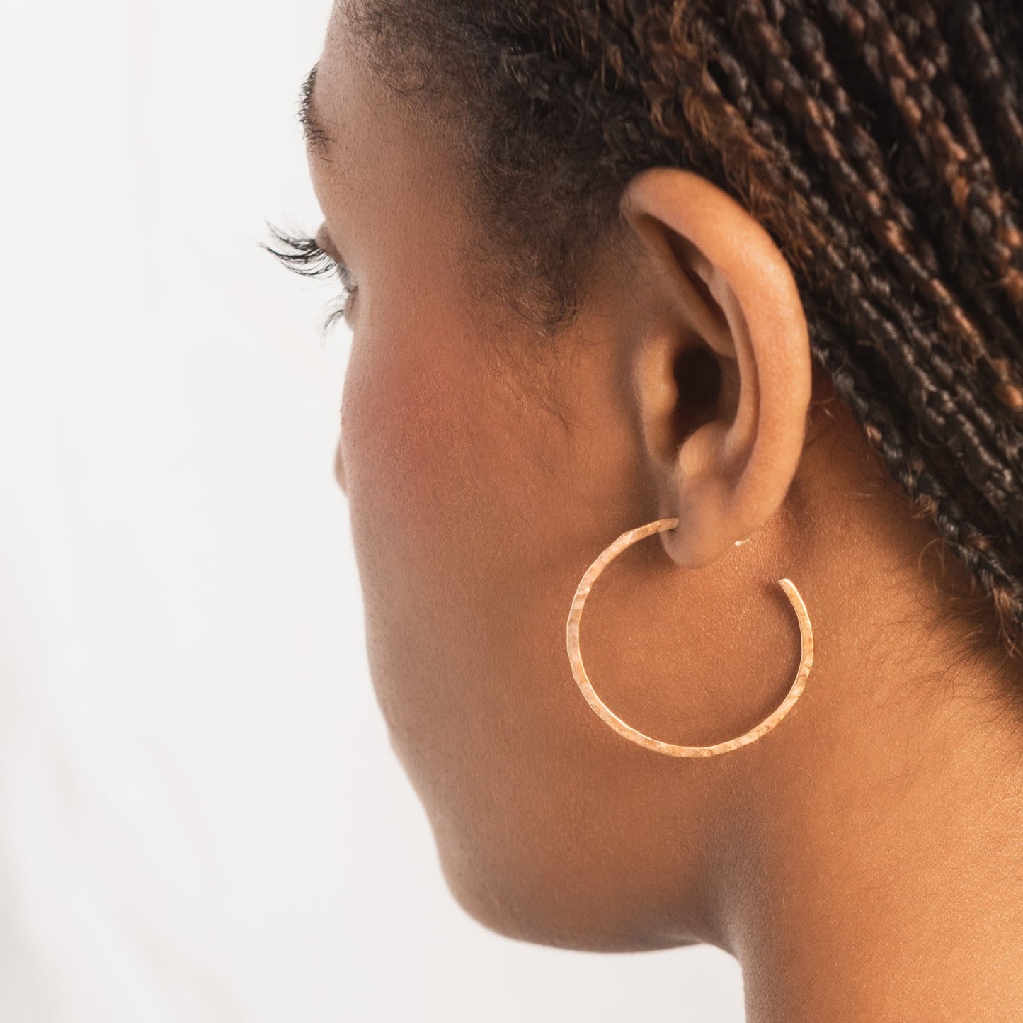 solid 9ct gold medium sized hoops on model