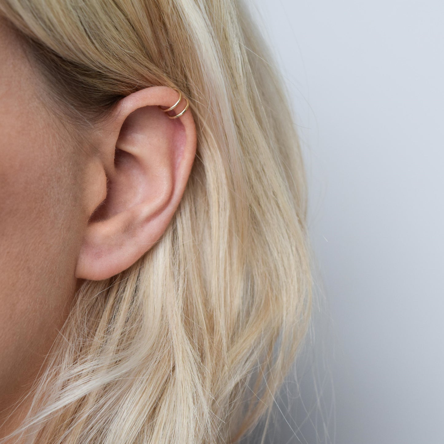 9ct gold double helix cuff worn on blond model