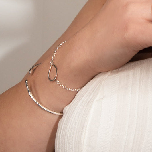 teardrop bracelet worn alongside molten cuff bangle