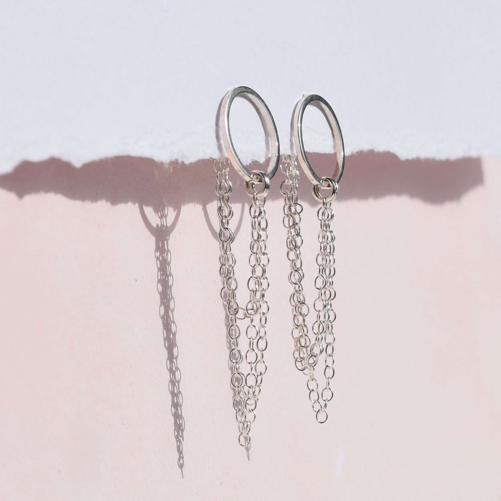 esme earrings side angle on pink and white background