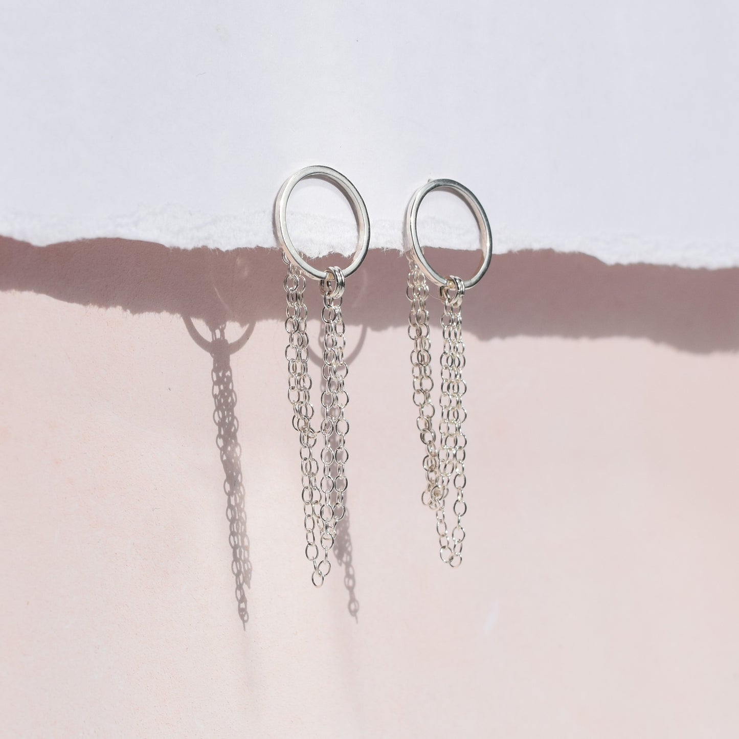 Esme earrings on pink and white background