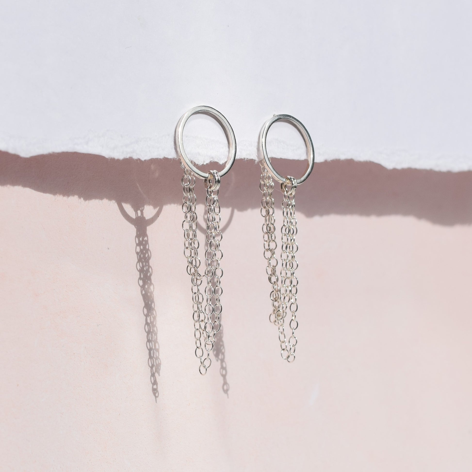 Esme earrings on pink and white background