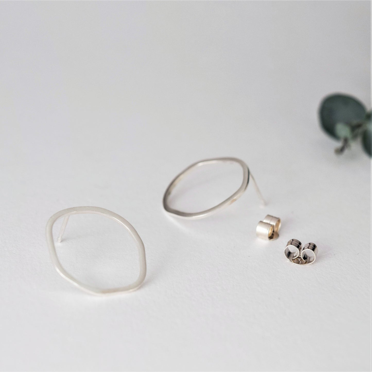Open Oval stud earrings on white background