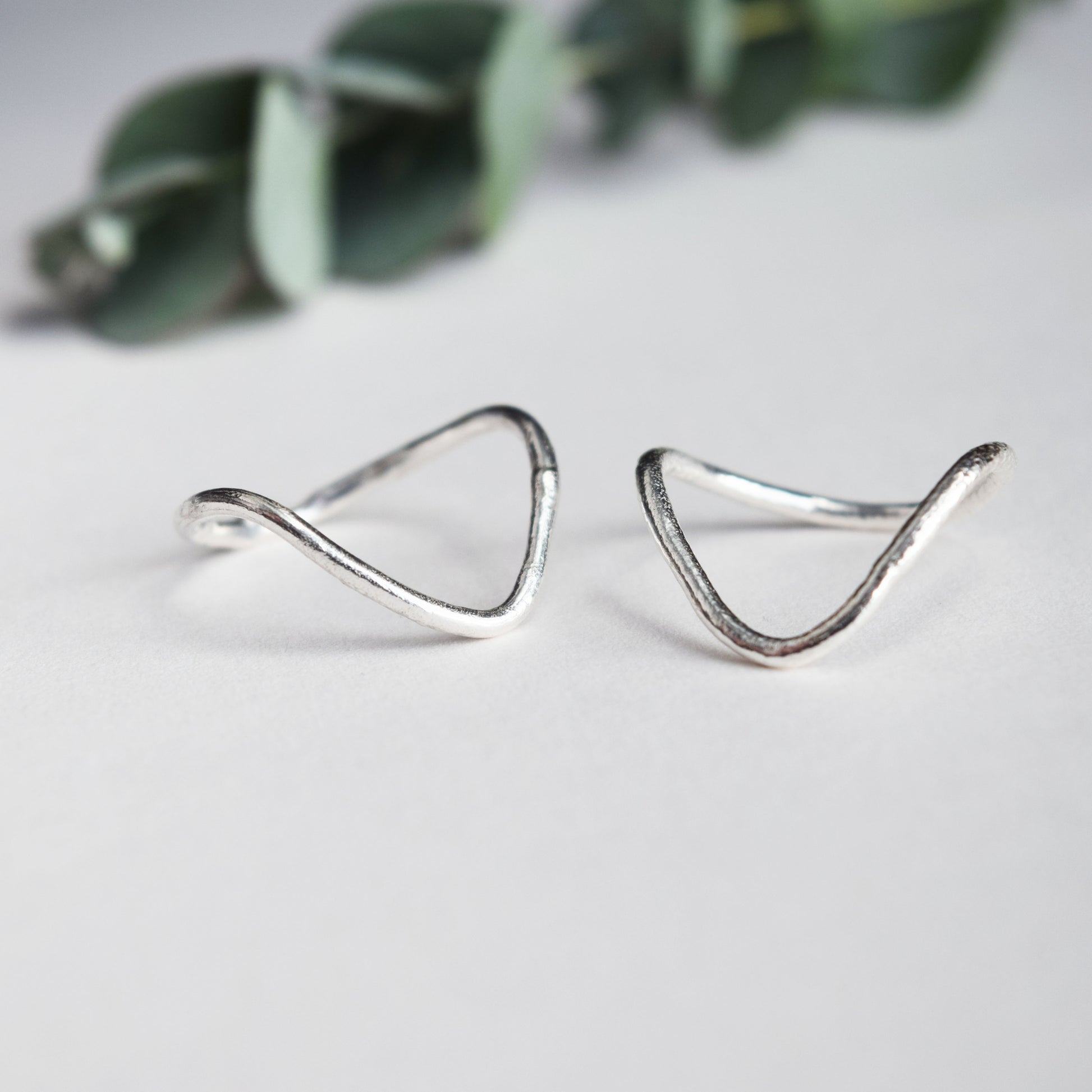 Deep V ring with molten texture on white background