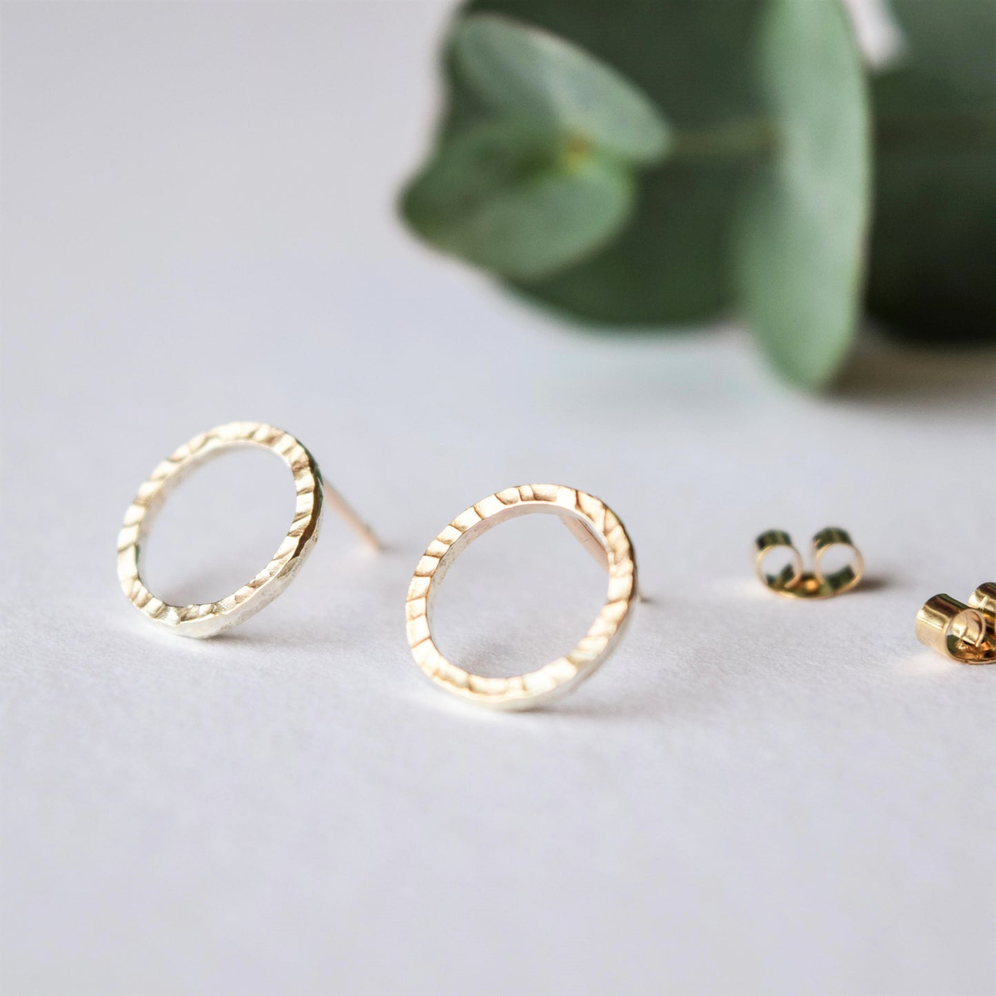 9ct gold dash circle studs close up to show texture