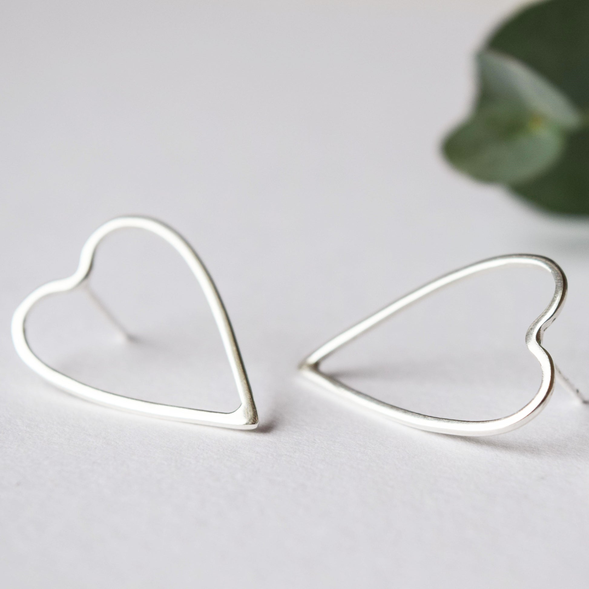 product image showing close up of silver heart earrings