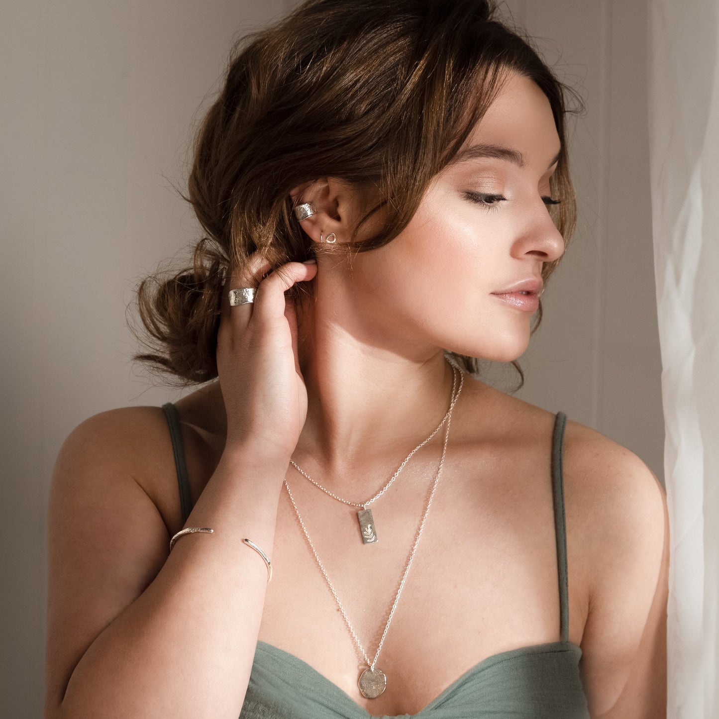 Model wears molten wrist cuff alongside a selection of other MUKA studio pieces including the wide molten band and ear cuff