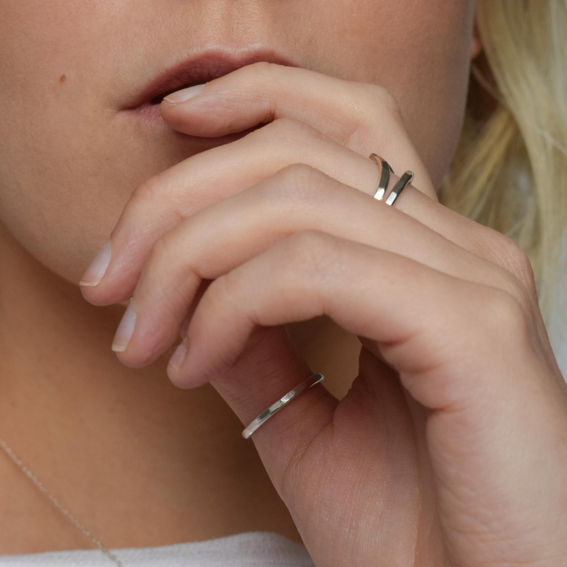 Chevron stacking rings worn over several fingers