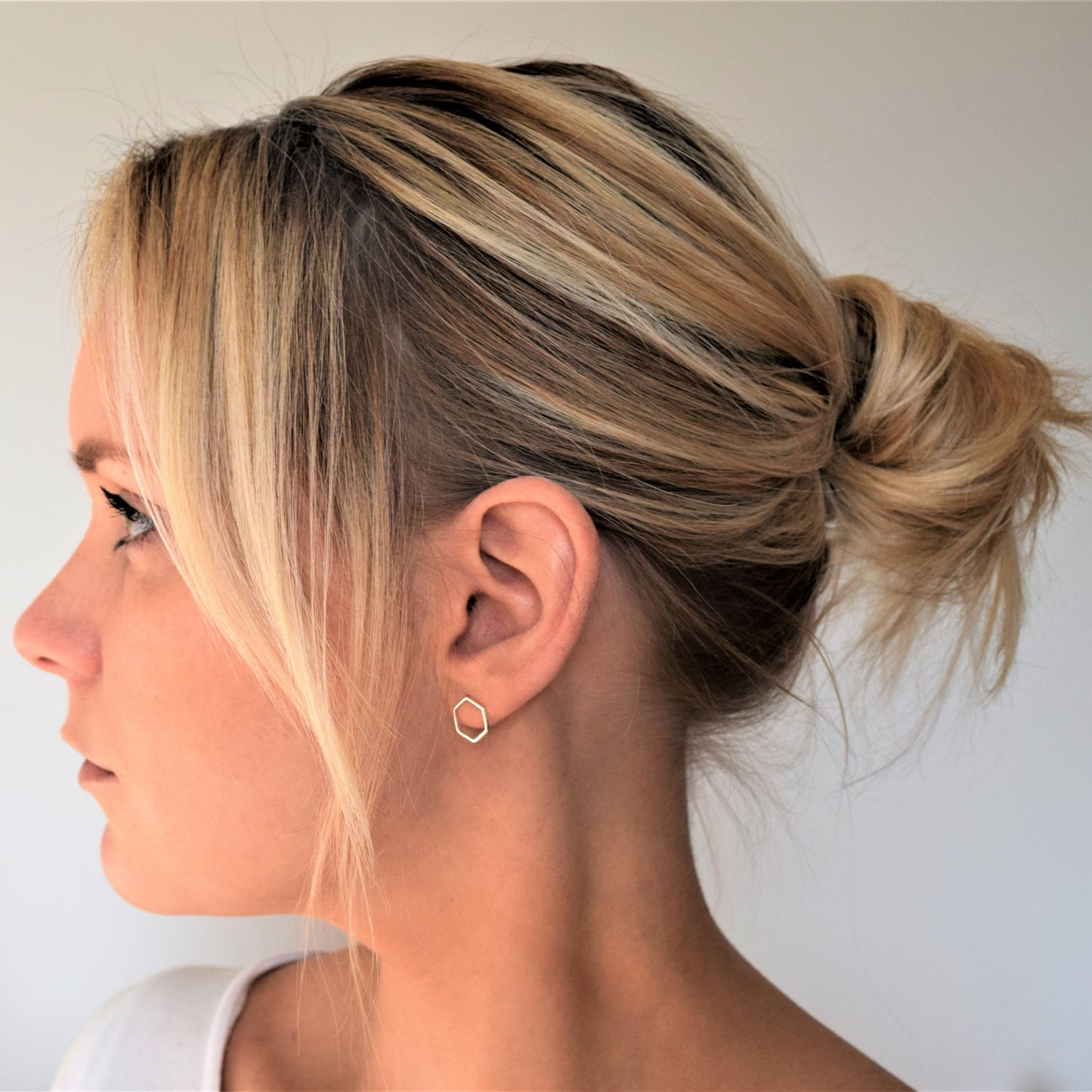 Silver hexagon studs worn by model