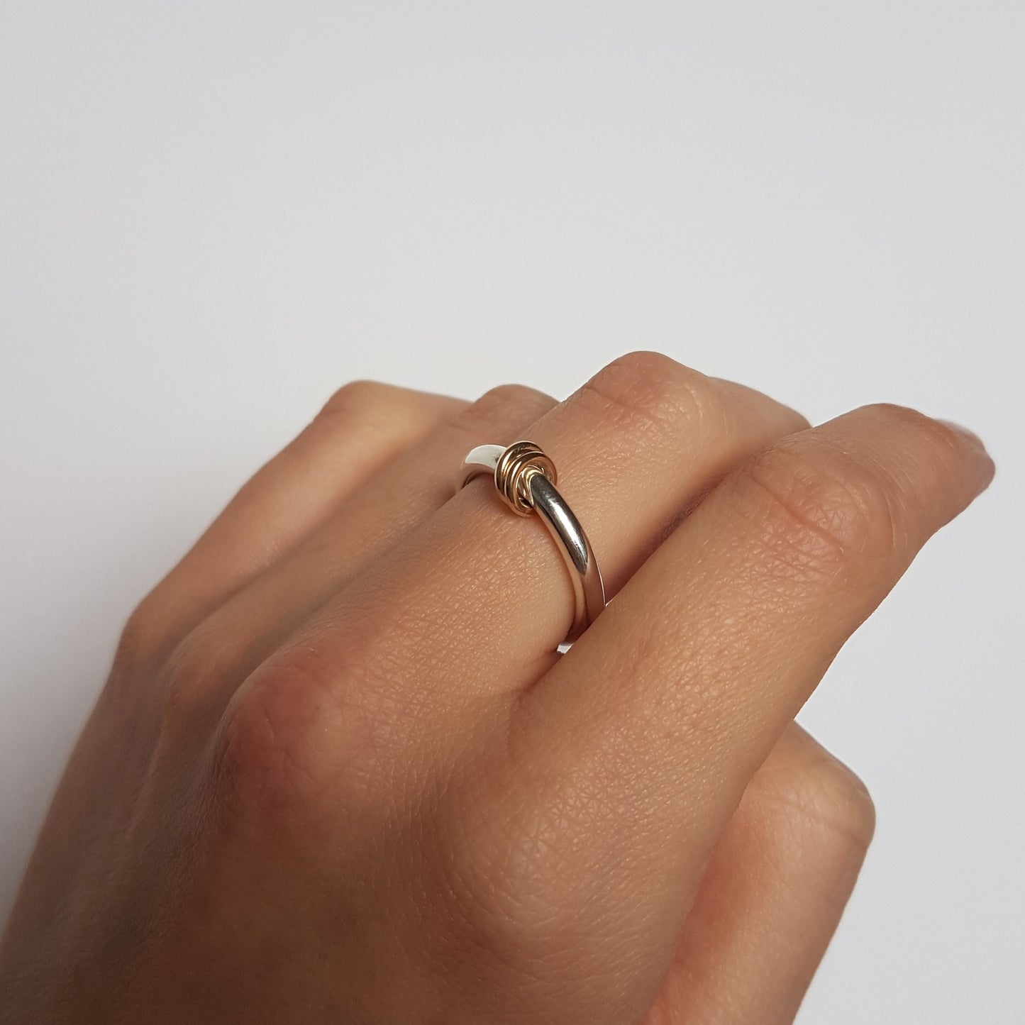 Hoop spinner ring worn on middle finger