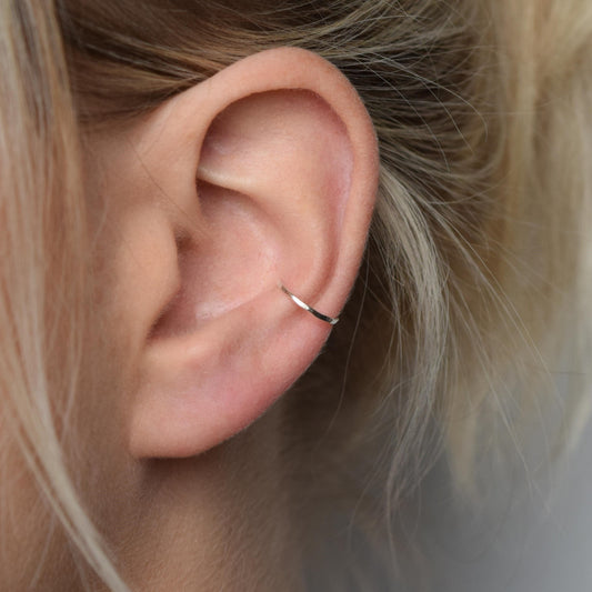 silver conch cuff worn by blond model