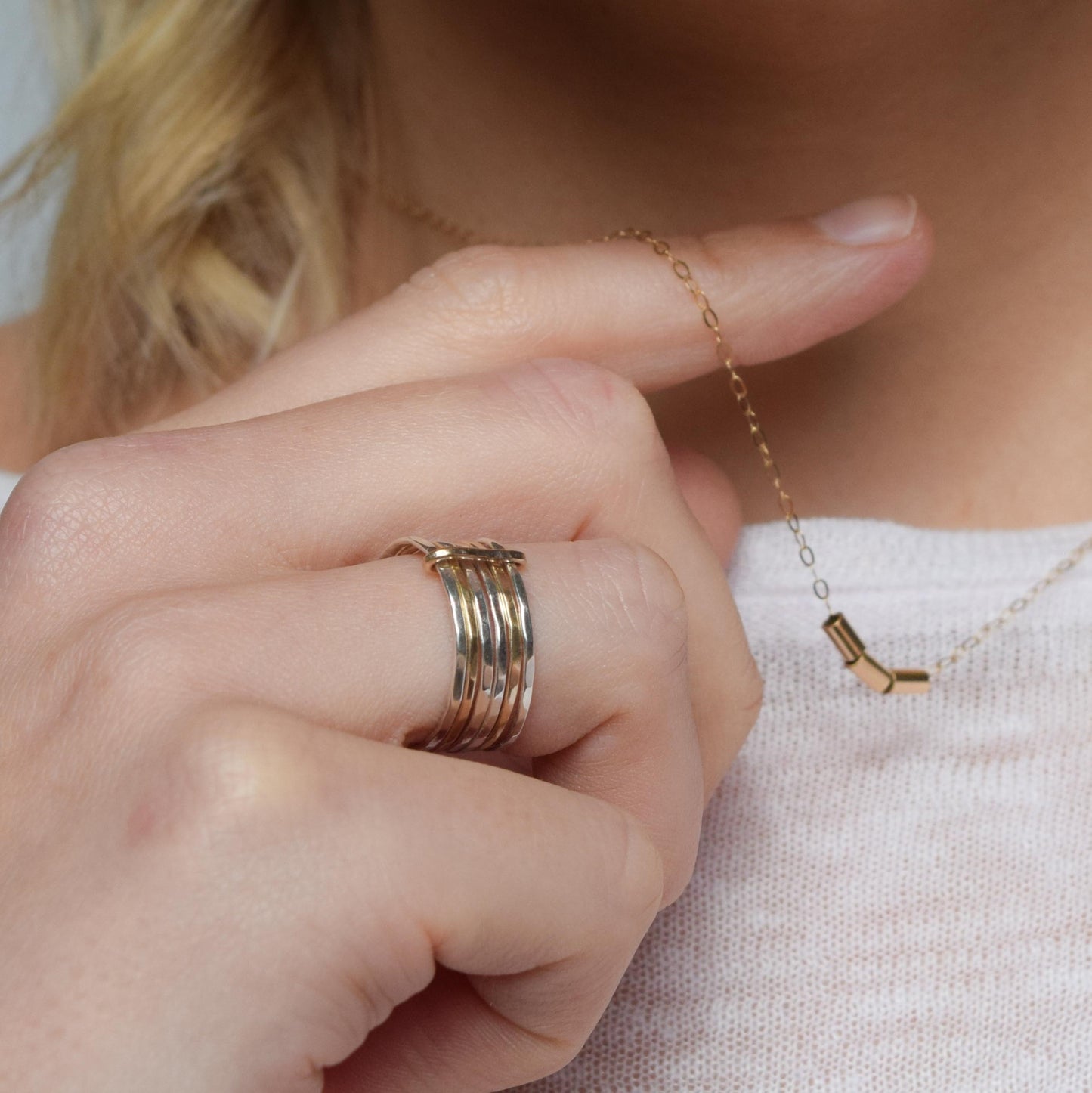 silver and gold stacking set worn on ring finger