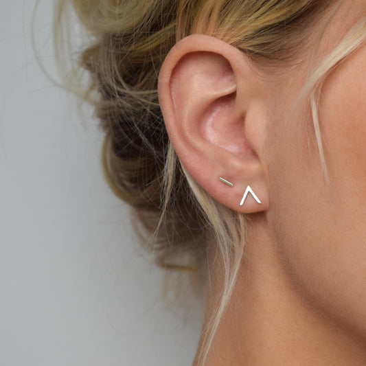 silver handmade chevron stud earrings worn on model alongside silver bar studs