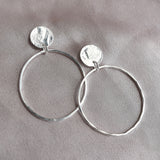 Hammered silver drop earrings made up of circles and ovals. Beaten texture and free moving open circle design, delicate and handmade in Scotland