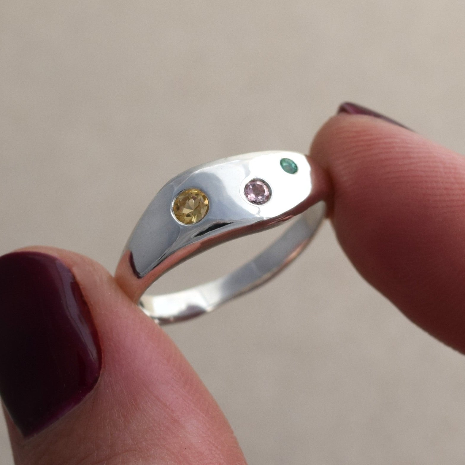 Recycled silver wave ring with citrine, pink sapphire and emerald stones set into the silver band. Colorful and fun ring handmade in UK