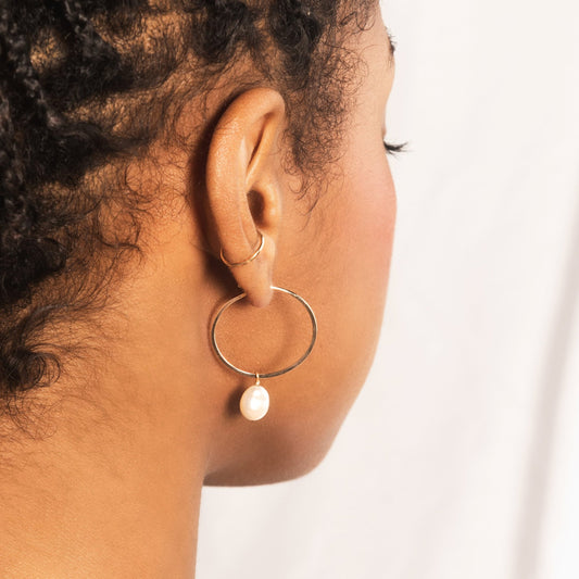 9ct gold hoop earrings with a keshi pearl hanging from them worn by model