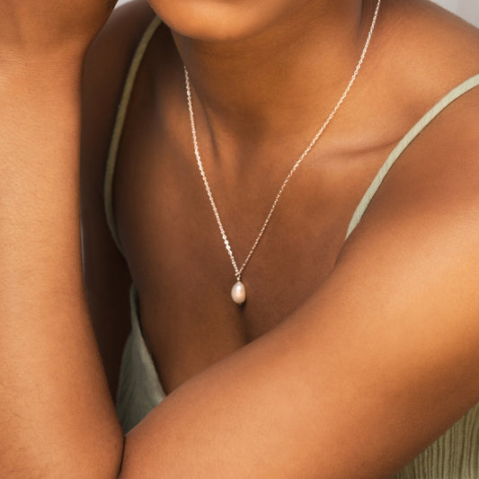 close up of model wearing silver pearl necklace