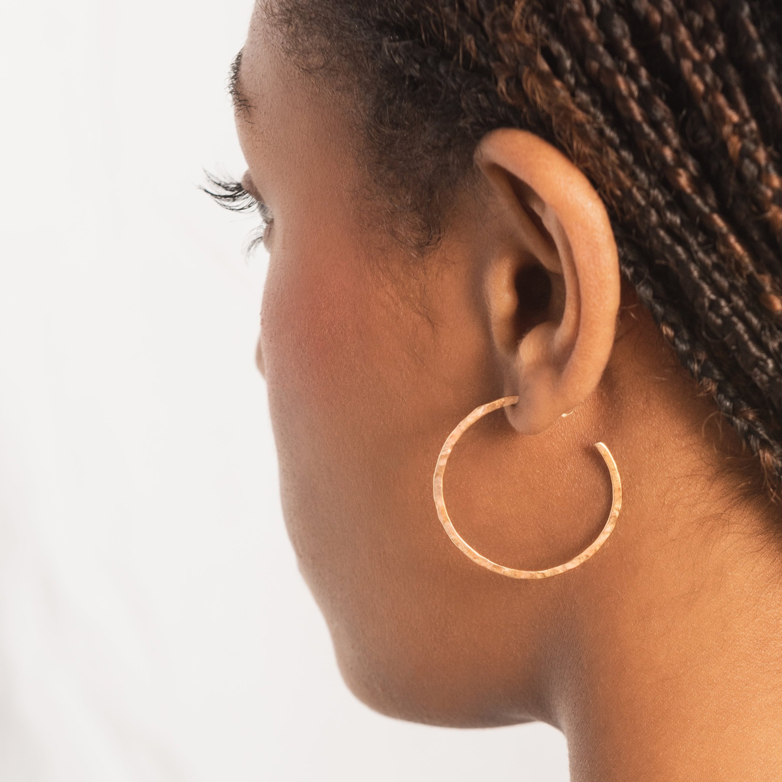 solid 9ct gold medium sized hoops on model