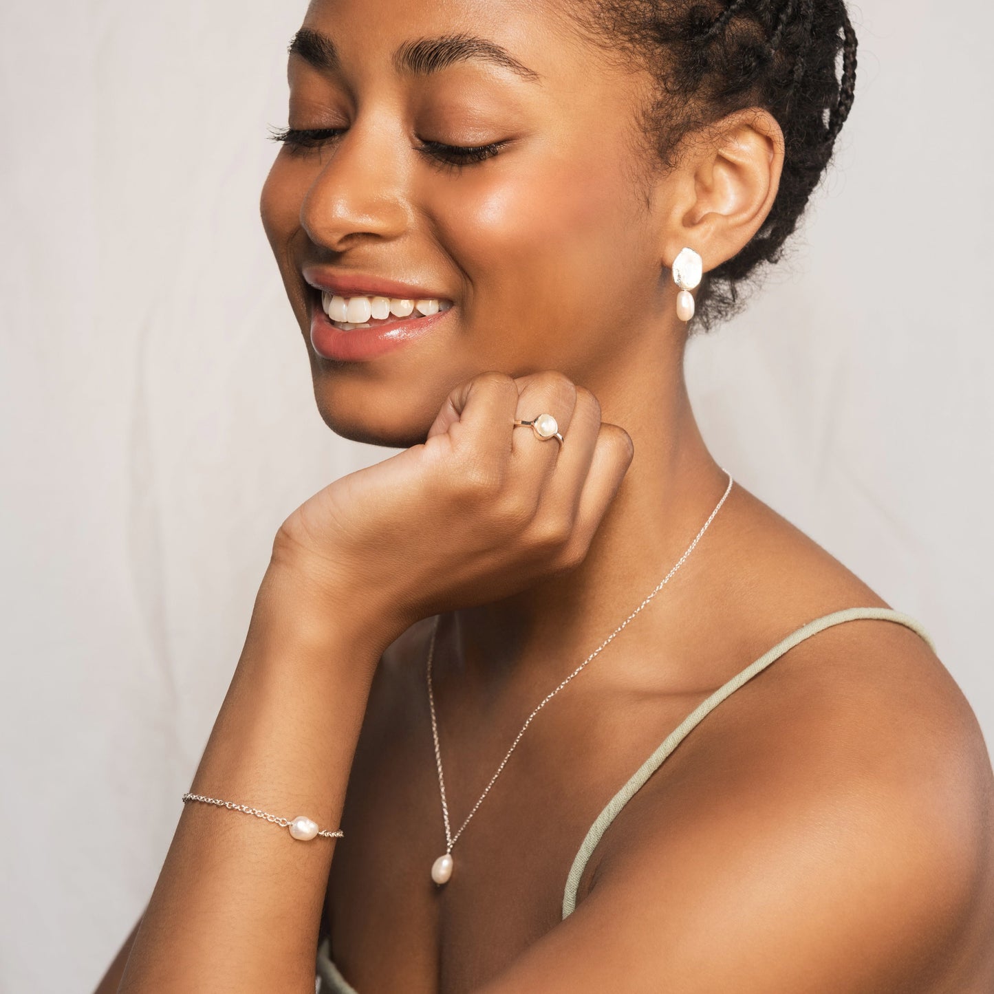 model wear silver pearl bracelet, necklace and Bella earrings from the Grace collection