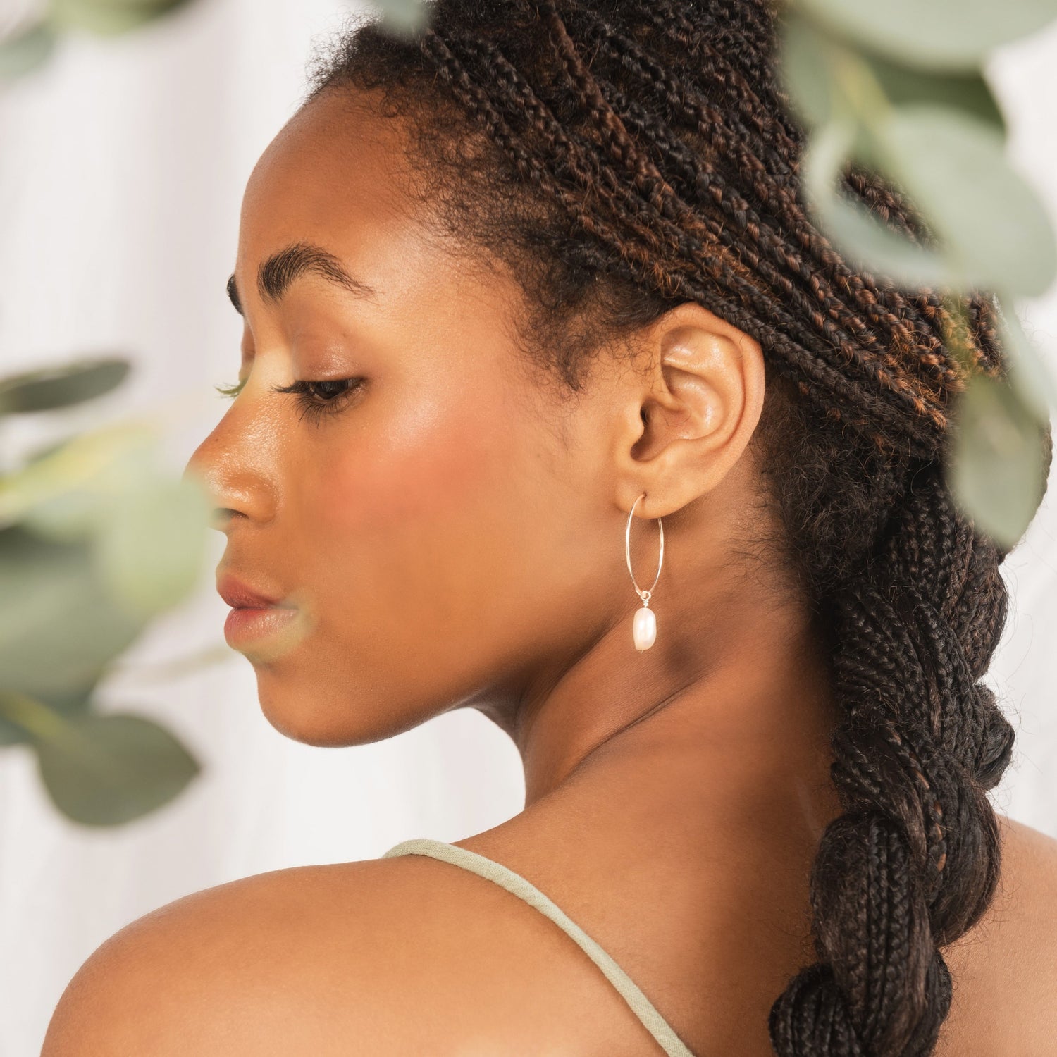 model wearing silver pearl hoops