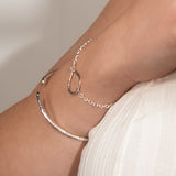 molten cuff bracelet worn alongside teardrop bracelet