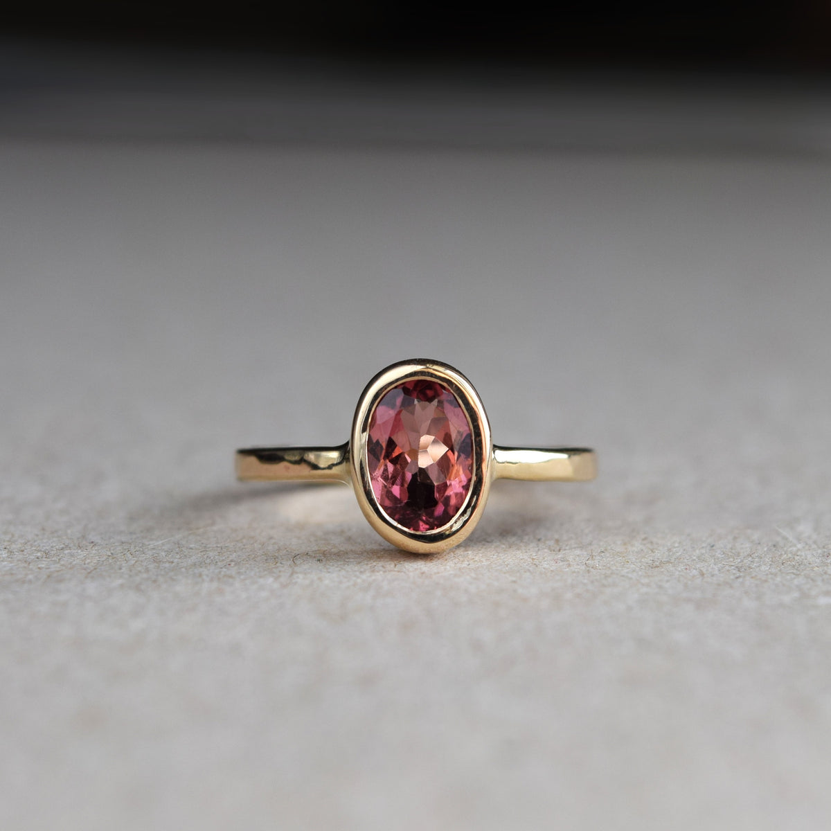 Beautiful pink tourmaline and yellow gold engagement ring handmade in recycled materials in Glasgow, Scotland