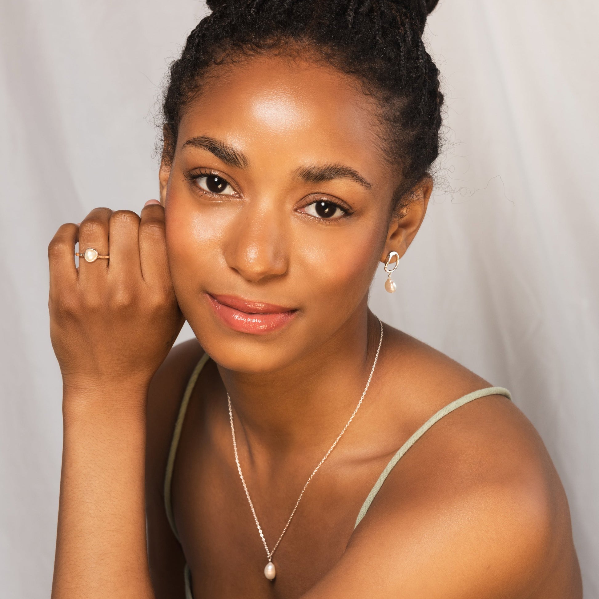 model wearing silver pearl ring alongside other pieces from the Grace collection