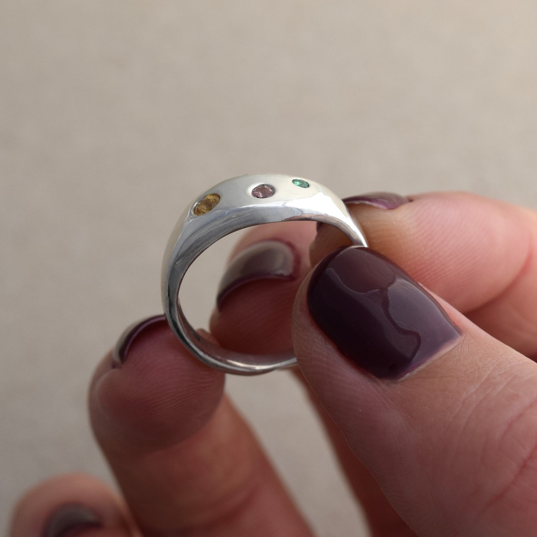 Recycled silver wave ring with citrine, pink sapphire and emerald stones set into the silver band. Colorful and fun ring handmade in UK