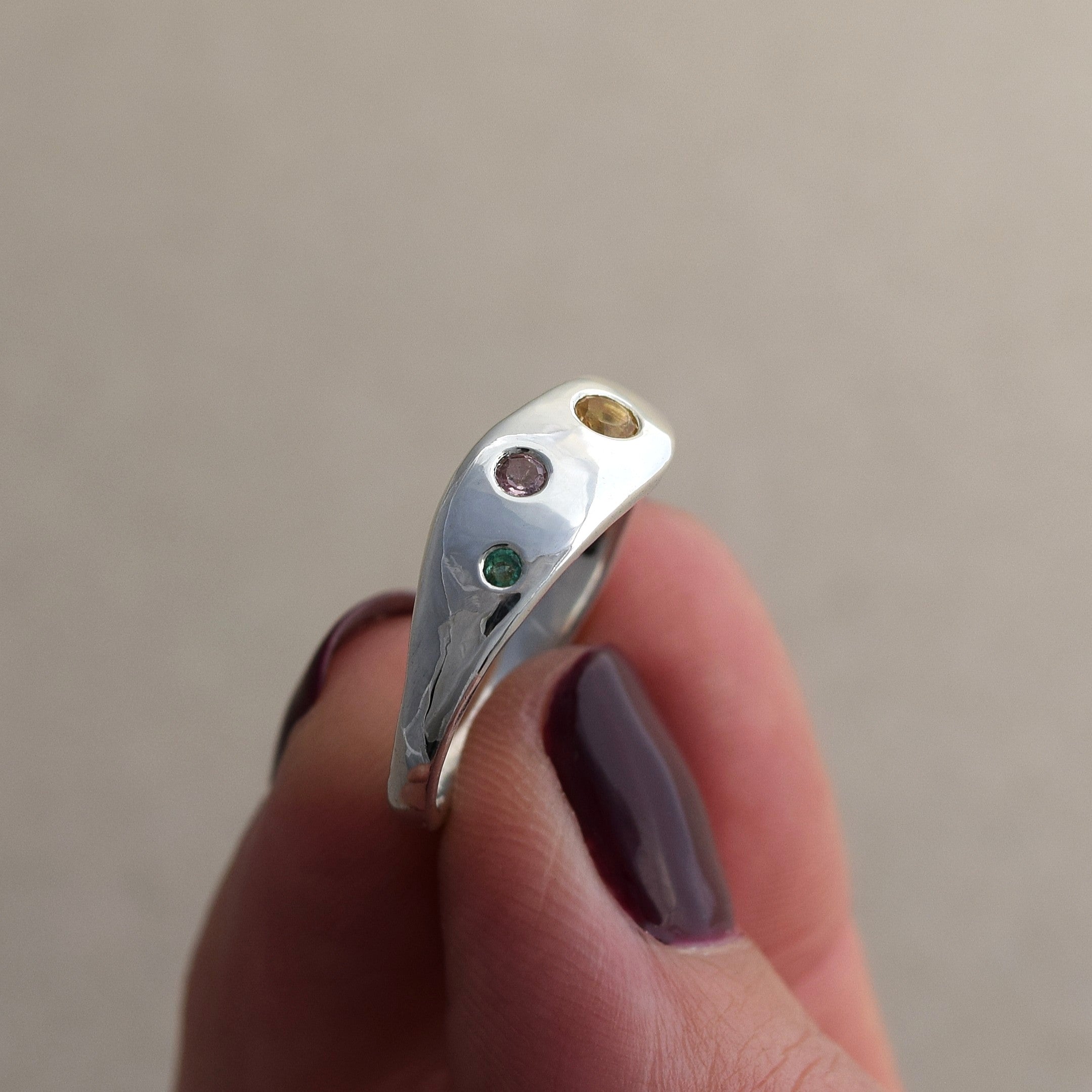 Recycled silver wave ring with citrine, pink sapphire and emerald stones set into the silver band. Colorful and fun ring handmade in UK