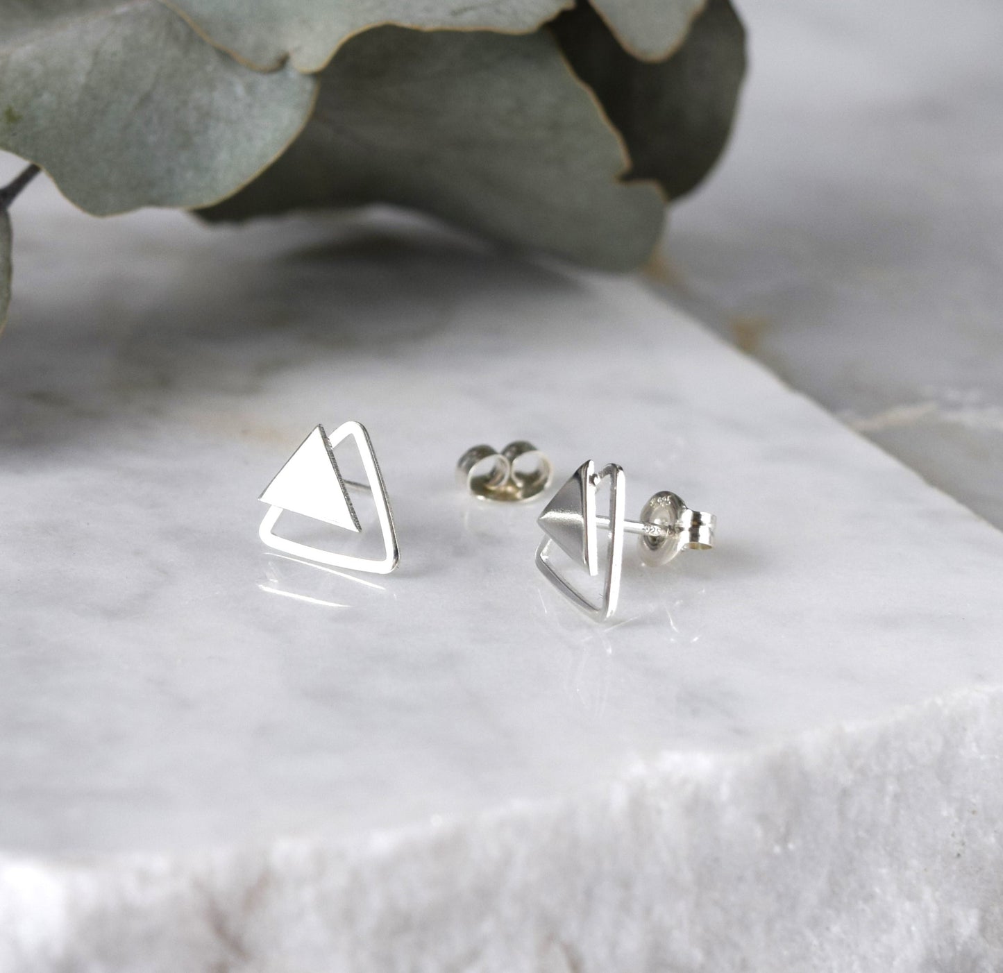 Product image of double triangle earrings on white background