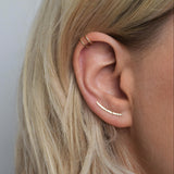 hammered gold ear climber worn with double helix cuff in gold