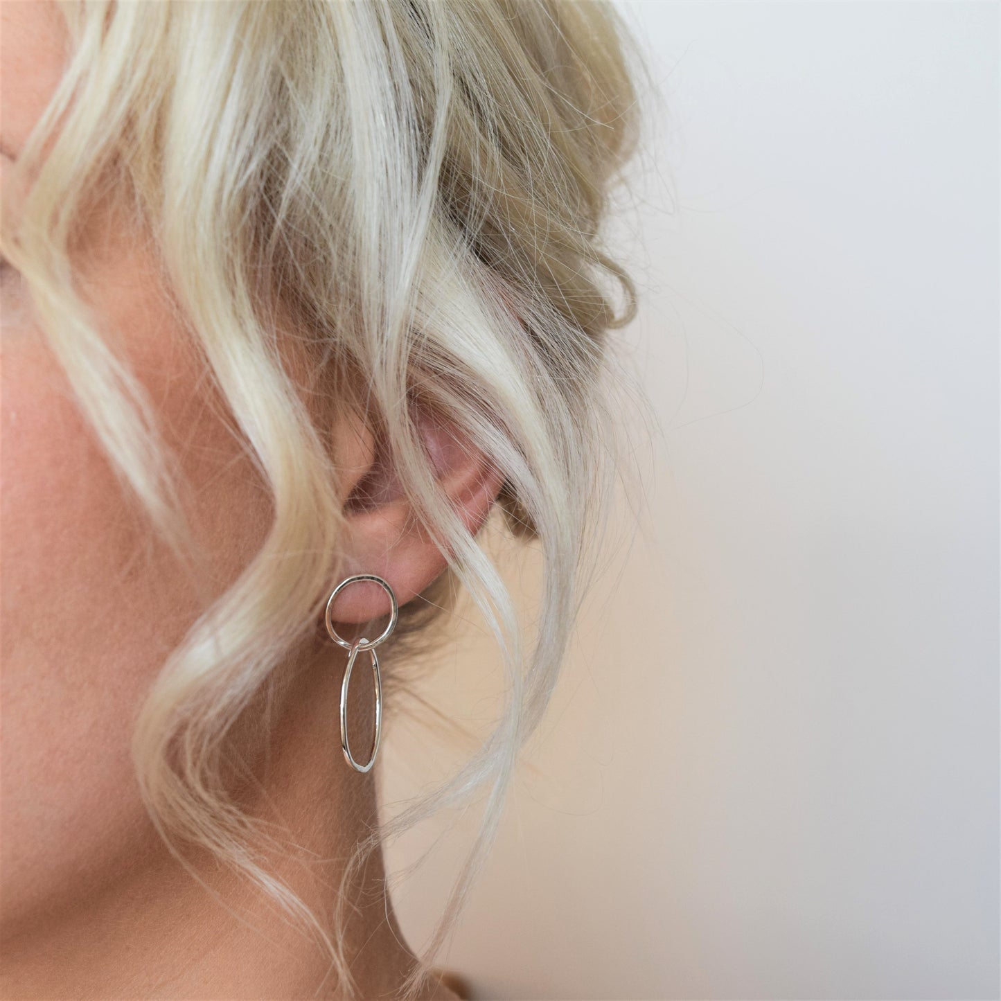 Double circle drop earrings on blond model