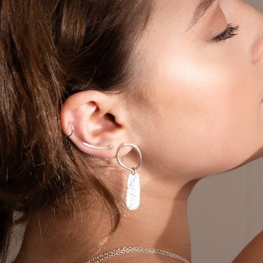 Ava drop earrings work by brown haired model along with other pieces of MUKA jewellery