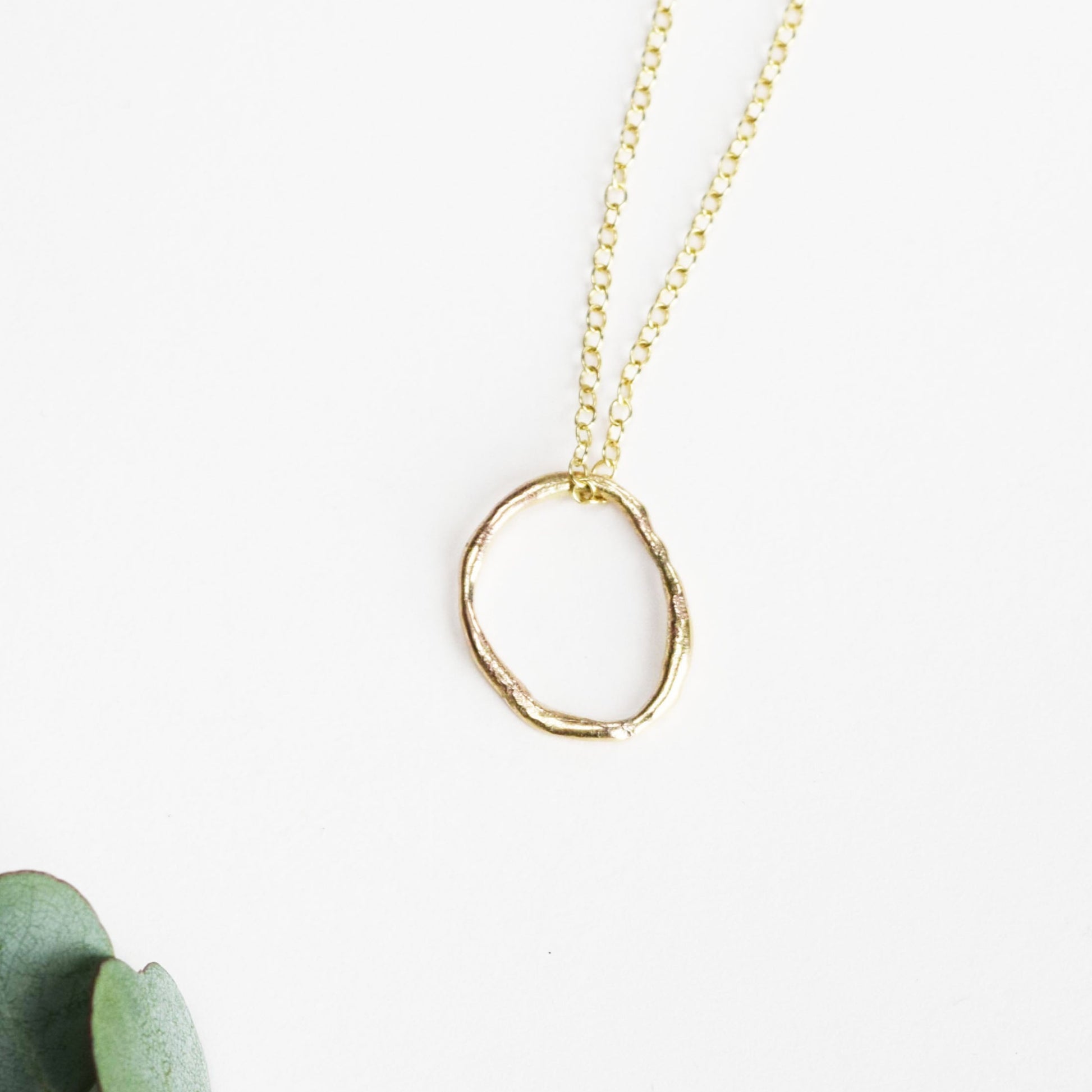 molten oval necklace on white background