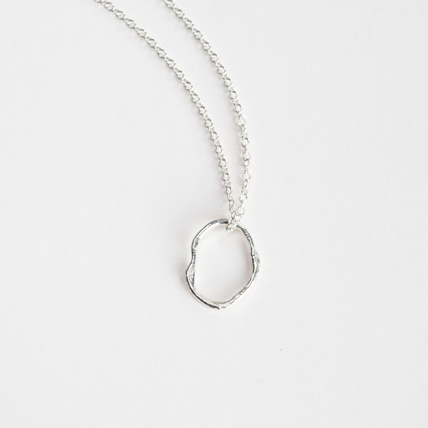 Molten oval necklace on light background