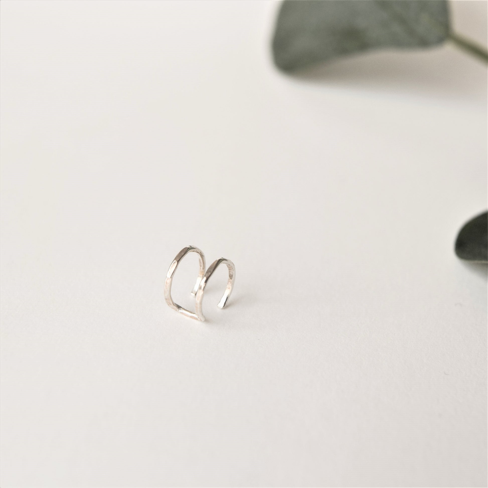silver double helix cuff on white background