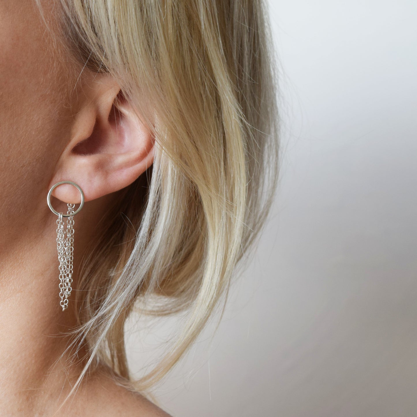 Blond model wearing silver Esme earrings
