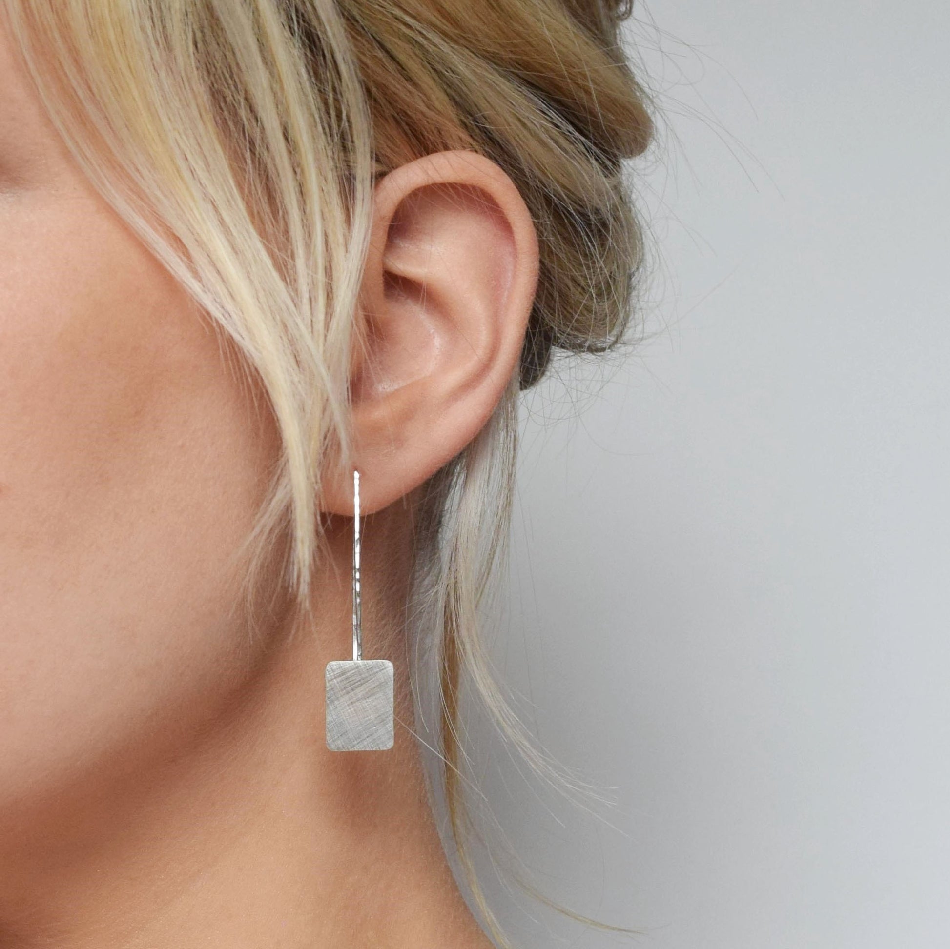 MUKA studio square drop earrings on blond model