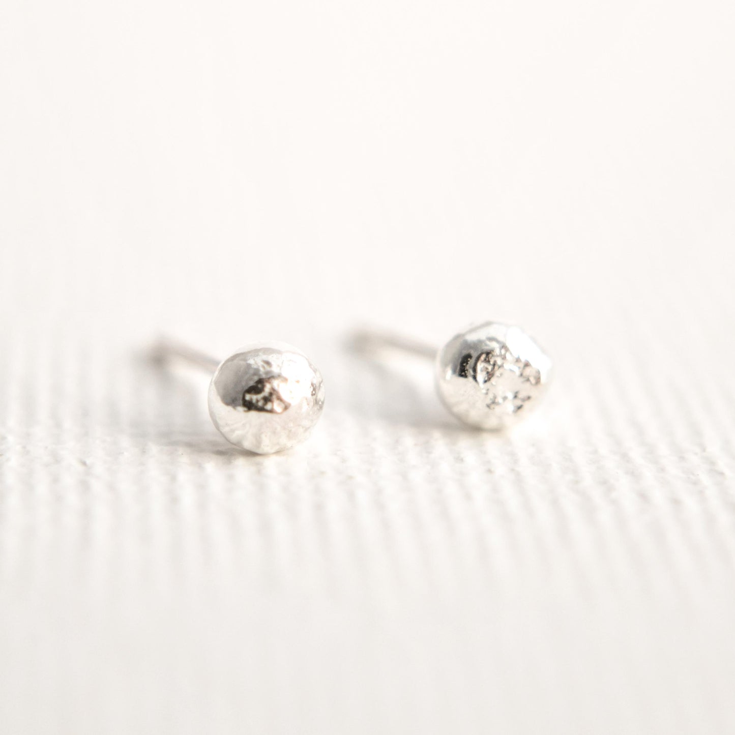 silver ball studs on white background image shows texture of silver