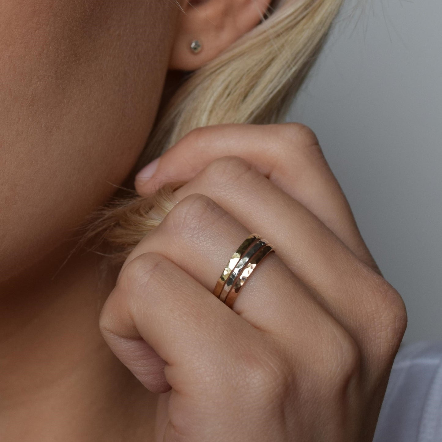 Trio of stacking rings worn by model on ring finger