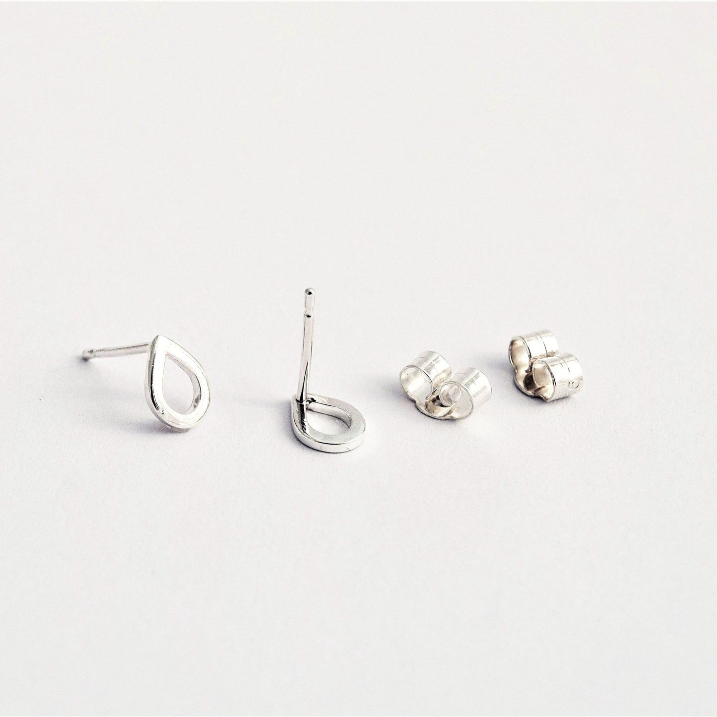 Close up product image showing teardrop studs with butterfly earring backs